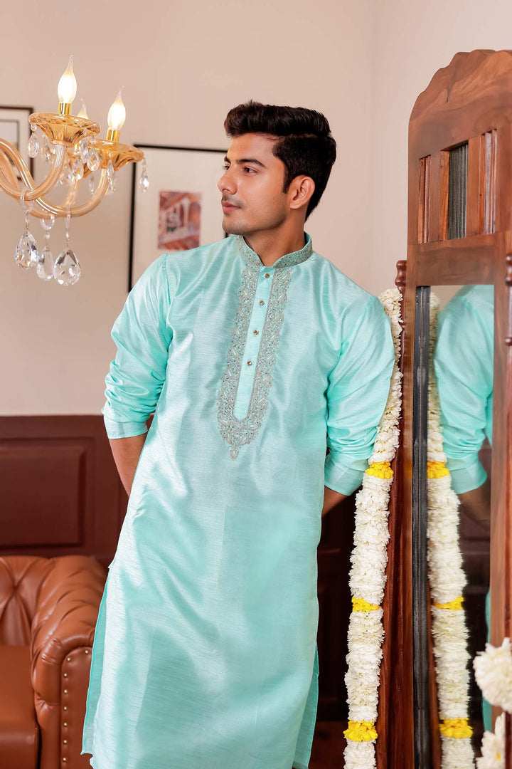 Sea Blue Raw Silk Kurta Suit with Intricate Embroidery on neckline.