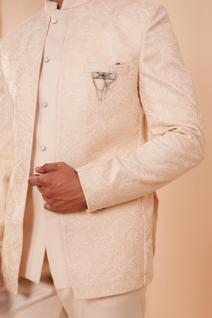 Cream Heavy Embroidered 3pcs Jacket Style Jodhpuri Suit.