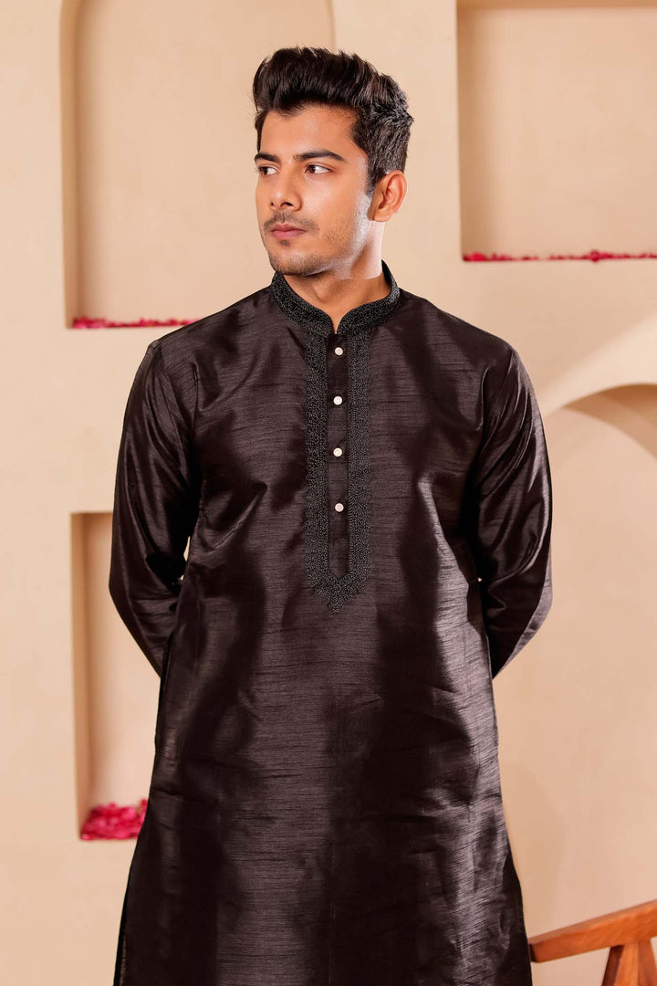 Black Raw Silk Kurta Suit with Intricate work on neckline.
