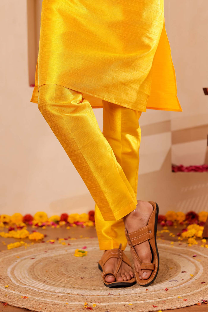 Yellow Raw Silk Kurta Suit with Intricate work on neckline.